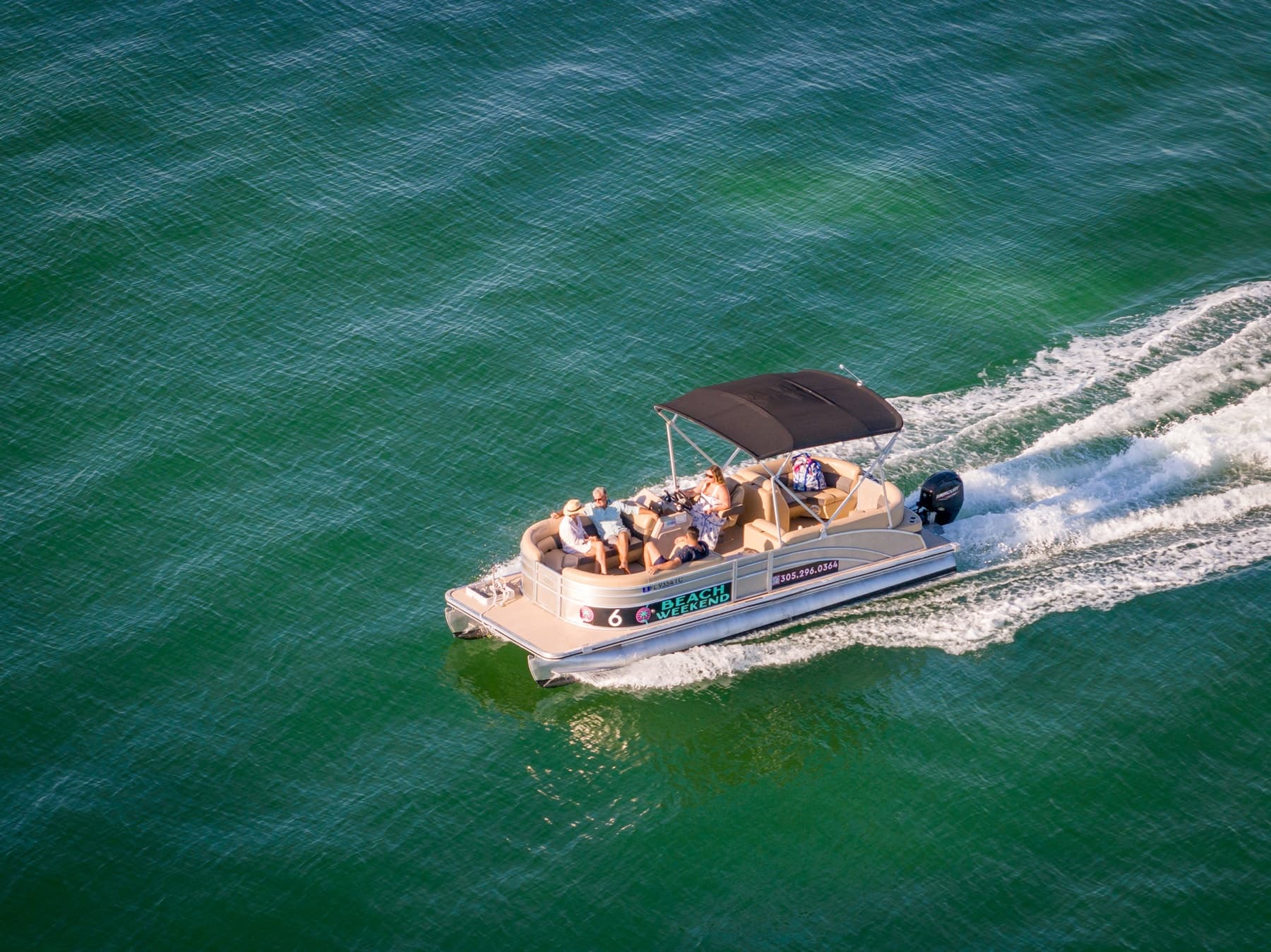Aerial view of pontoon boat cruising calm Key West waters