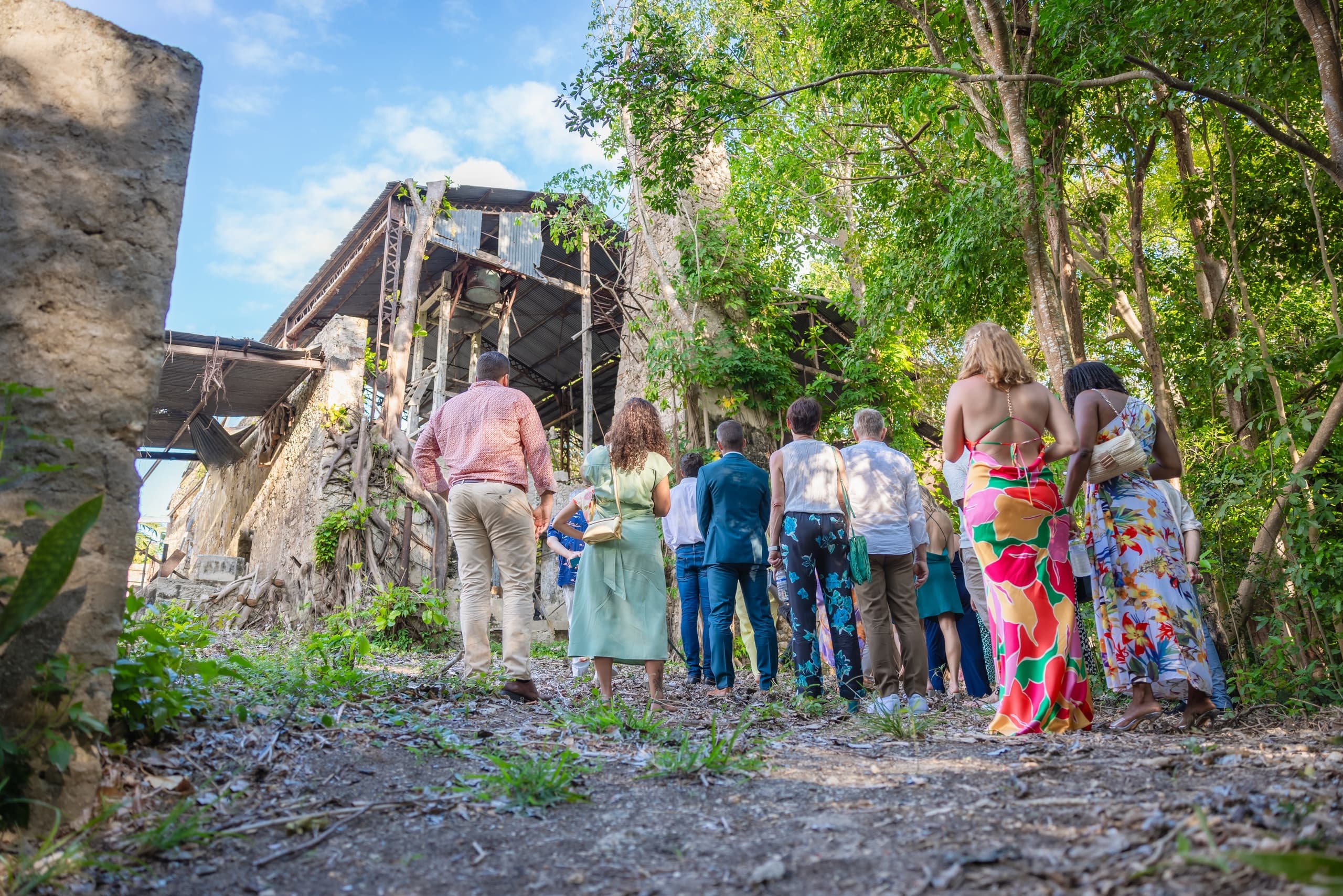 Group walking through tropical ruins on guided outdoor tour