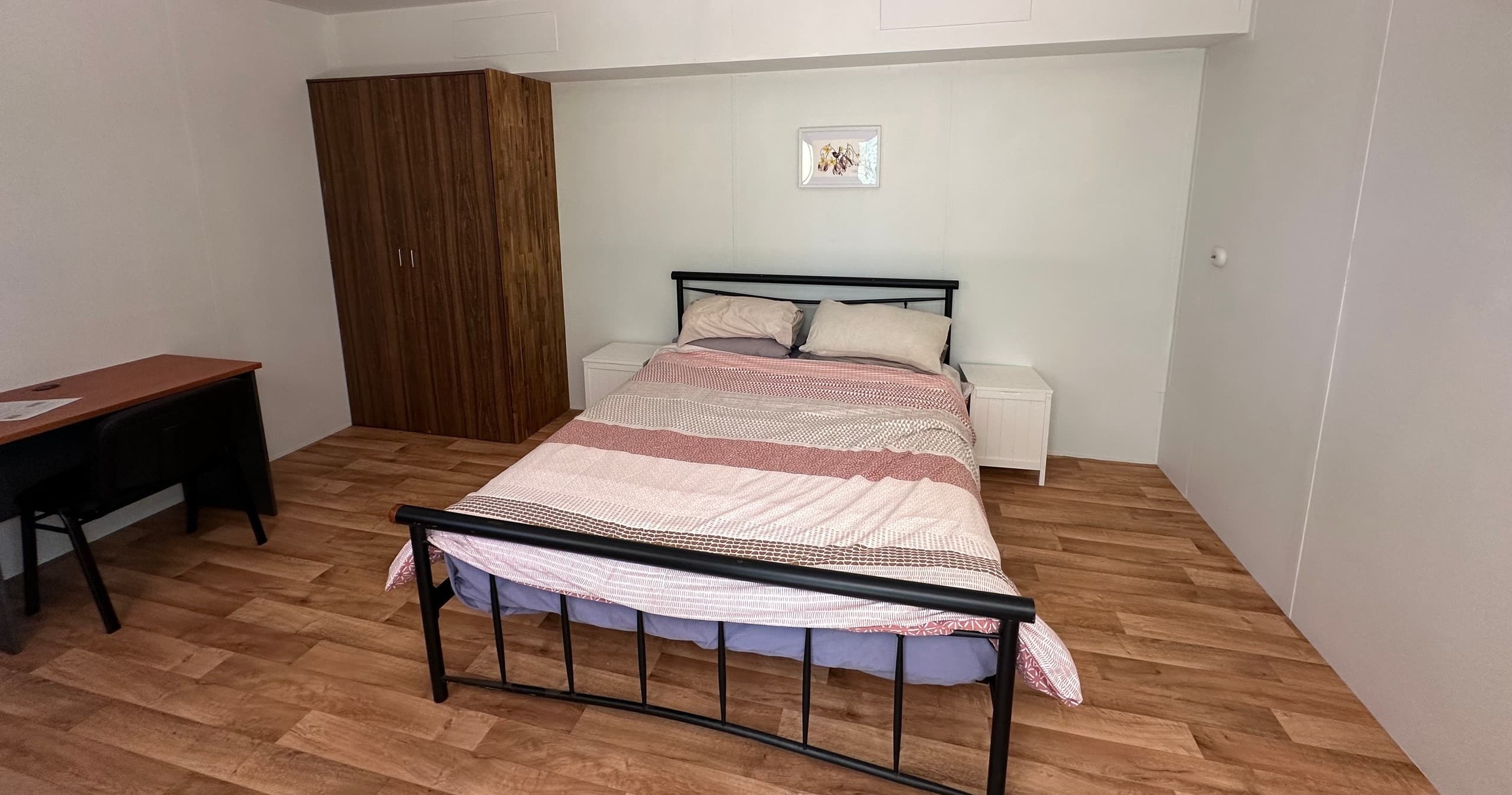 Cozy private bedroom with double bed, simple travel accommodation