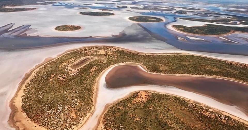 Aerial coastal scenic flight over tidal salt flats and islands