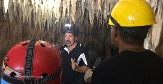 Guided cave tour with helmets exploring limestone caverns in Puerto Rico