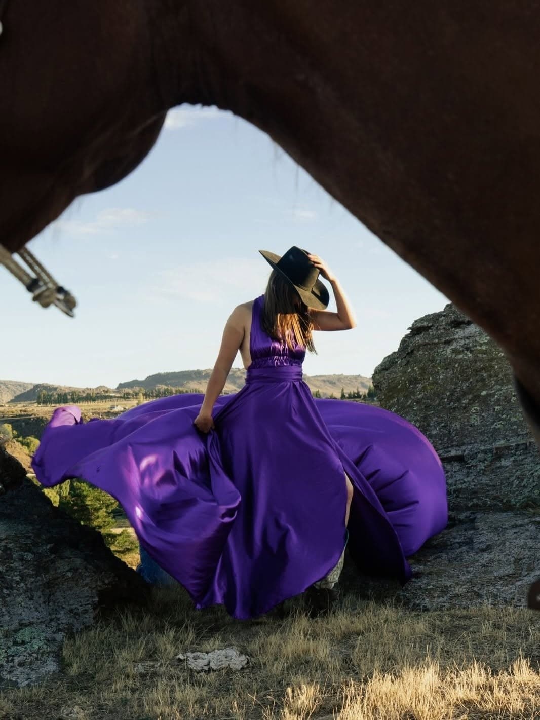Equestrian photoshoot with purple dress and galloping horse