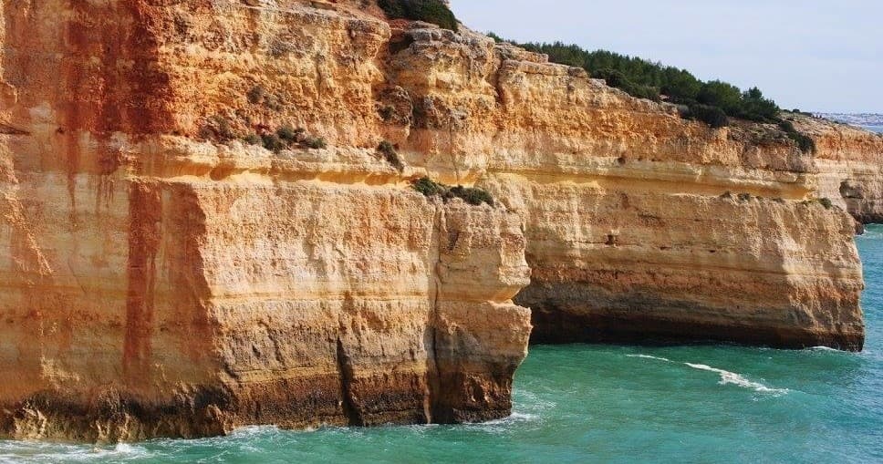 Dramatic limestone cliffs over turquoise Atlantic in Algarve