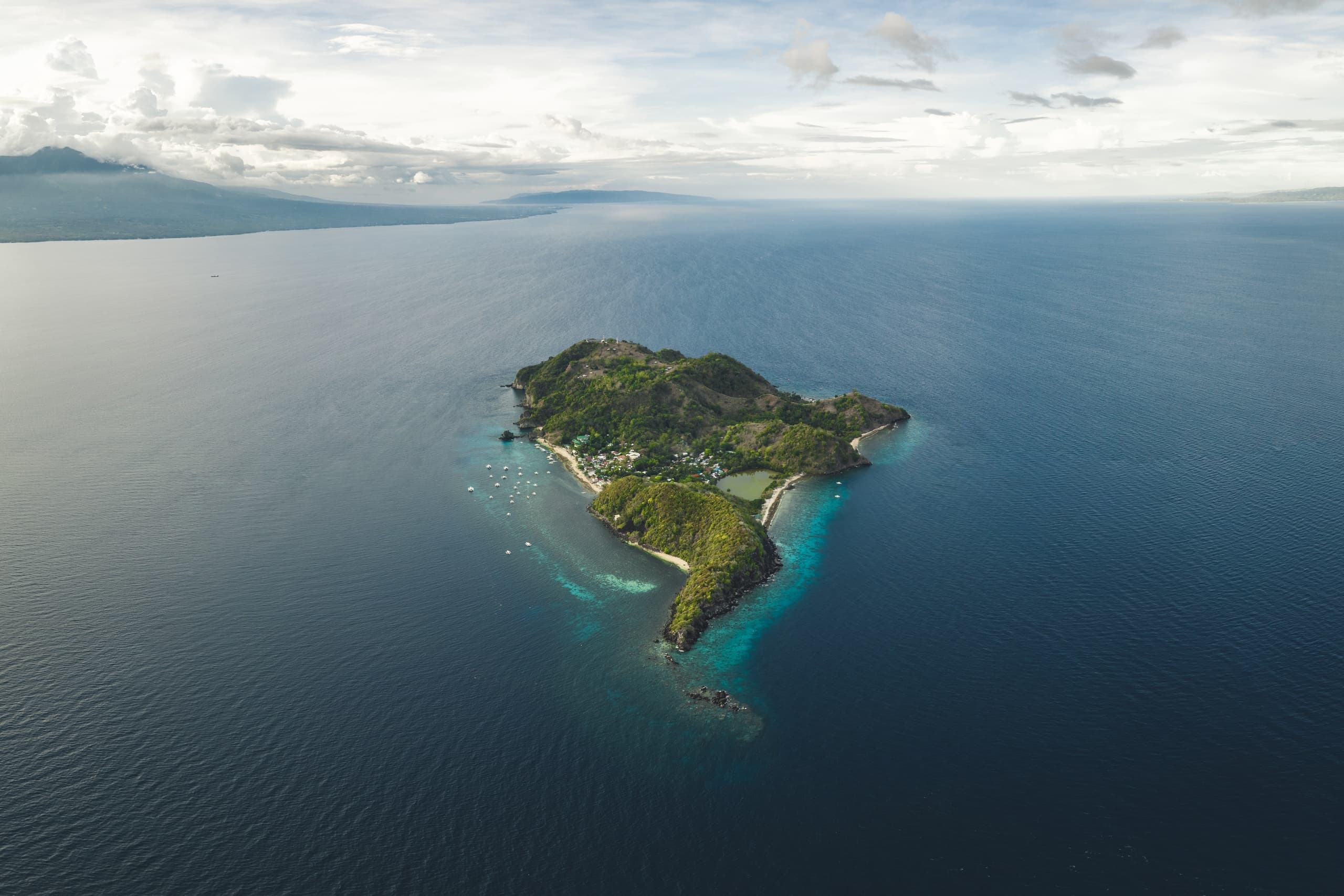 Aerial view of tropical island surrounded by turquoise ocean