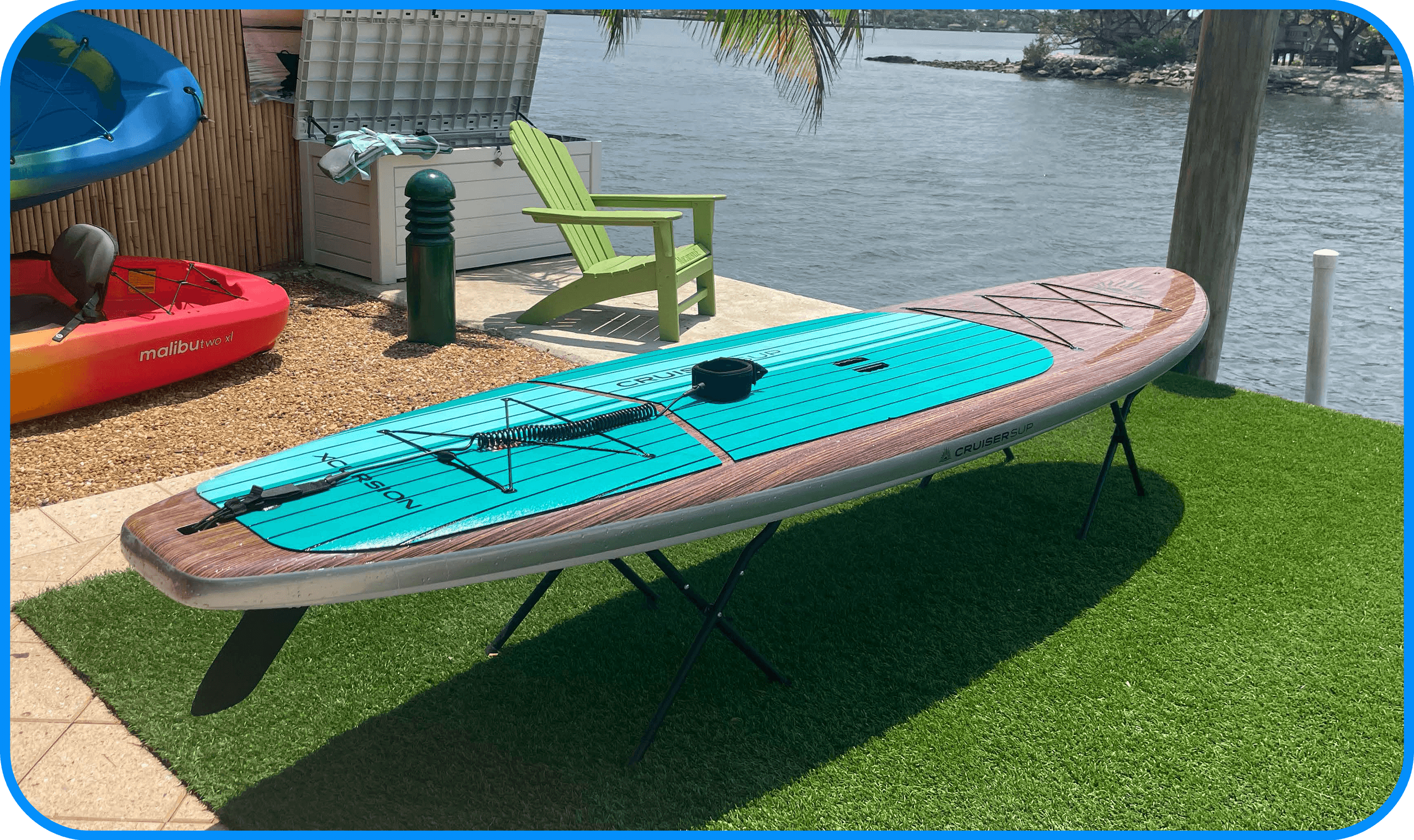 Stand-up paddleboard on dock with tropical waterfront view