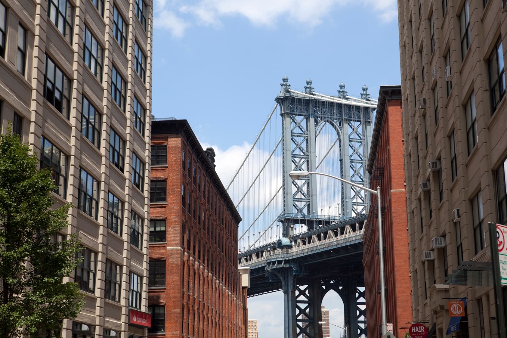 DUMBO street view with Manhattan Bridge framed by brick buildings