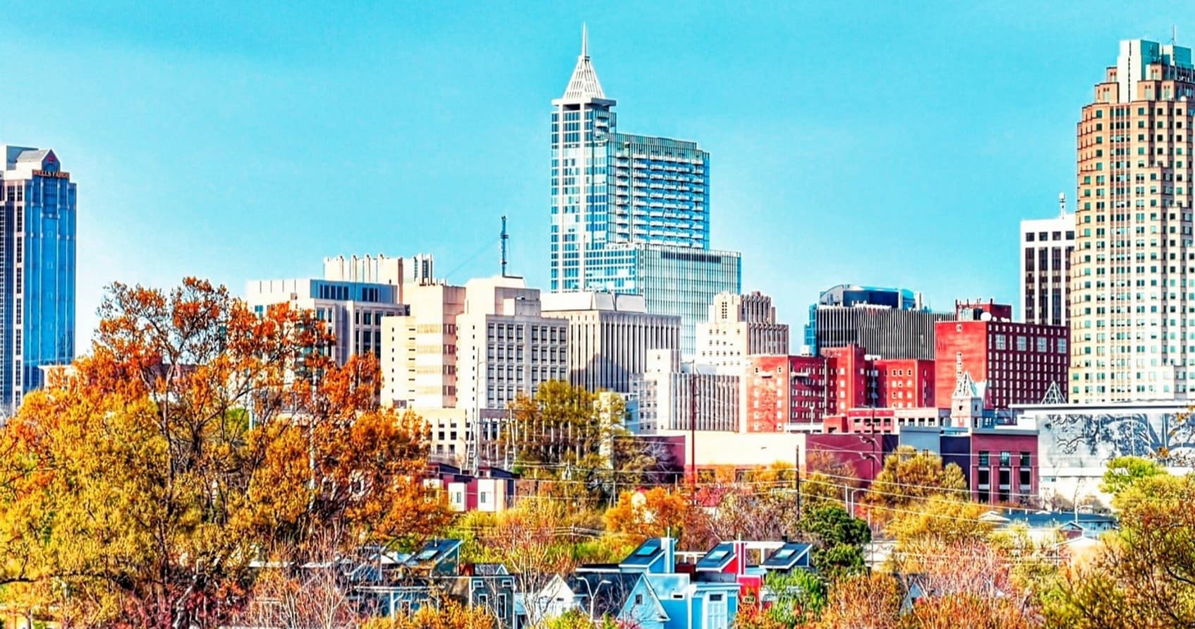 Autumn city skyline with downtown buildings and park views
