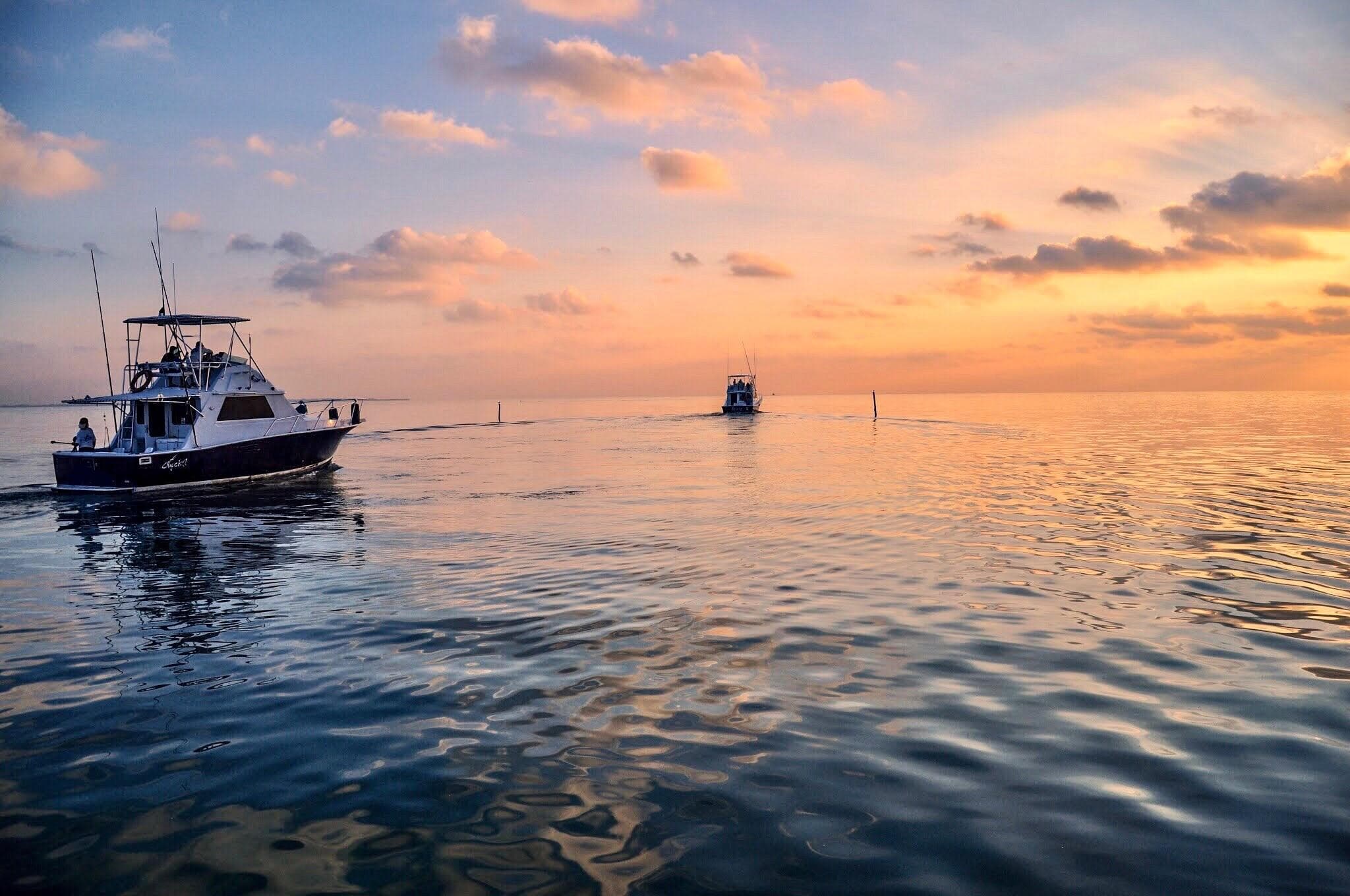 Fishing boat at sunrise on calm Caribbean waters off Cancun