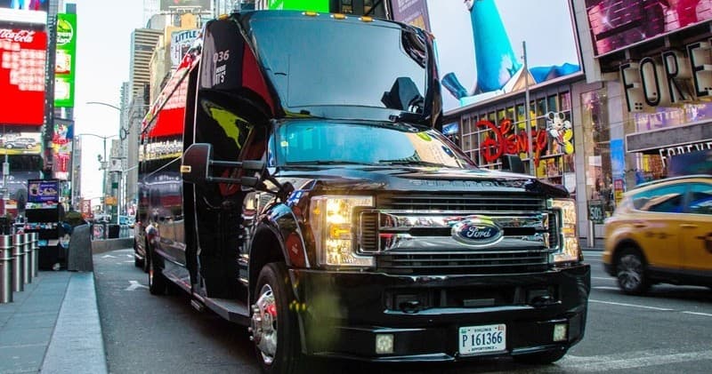 Luxury shuttle van parked in Times Square offering city transfers