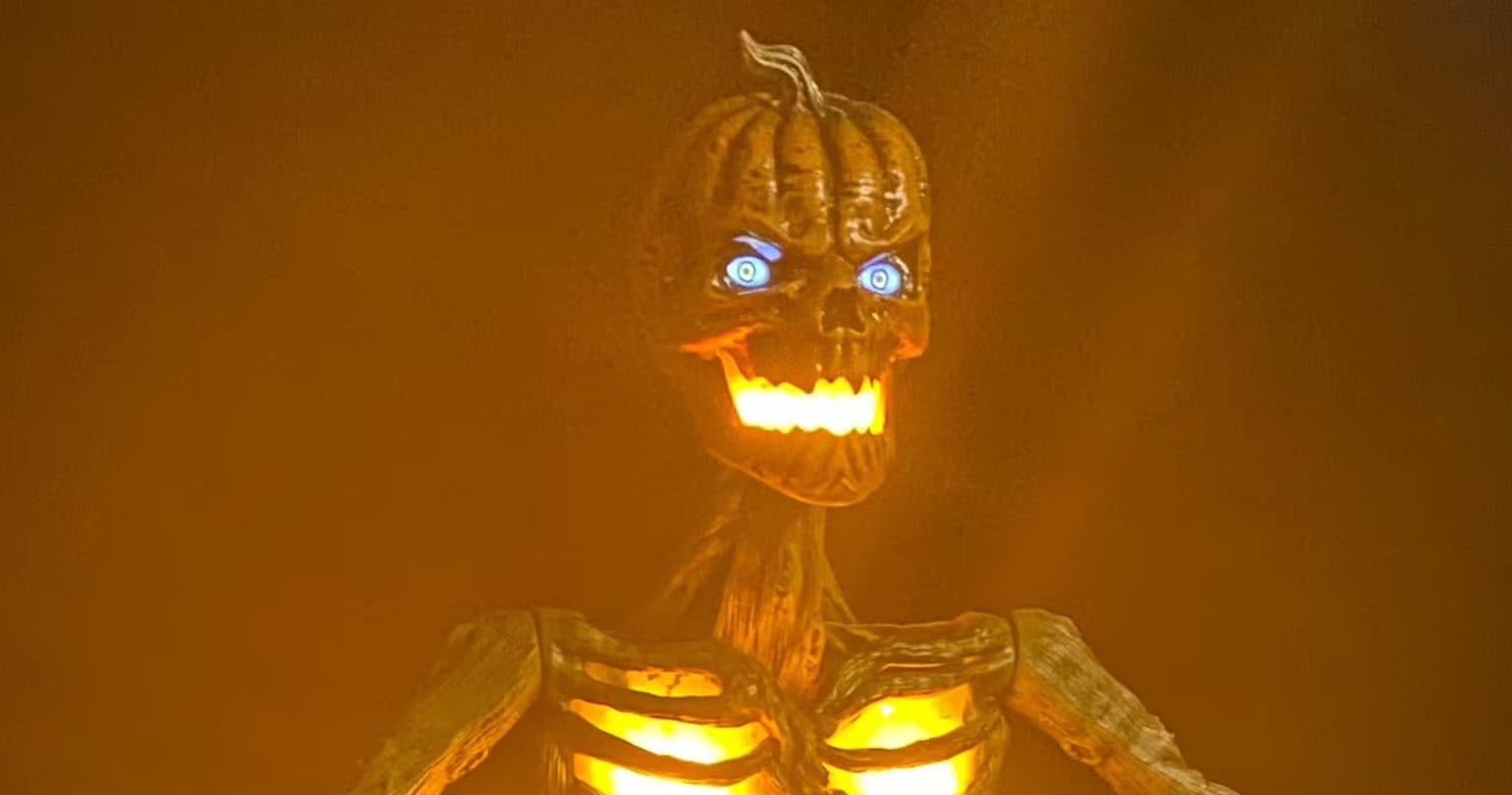 Glowing jack-o'-lantern skeleton prop in Halloween display