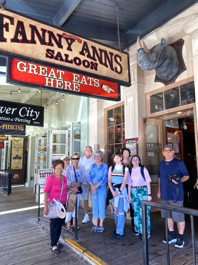 Historic downtown walking food tour group outside saloon