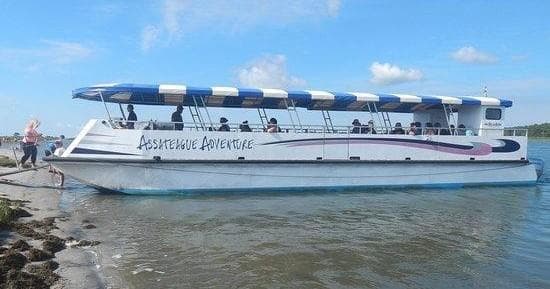 Covered sightseeing boat docked, calm bay tour and wildlife viewing