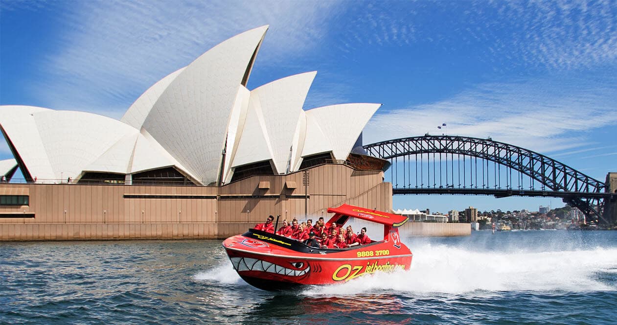 Jet boat speeding past Sydney Opera House and Harbour Bridge