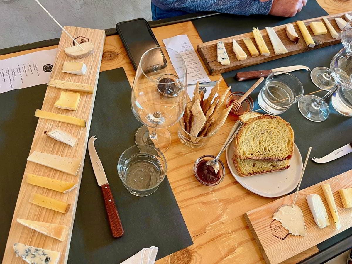 Artisanal cheese tasting board on wooden table at winery