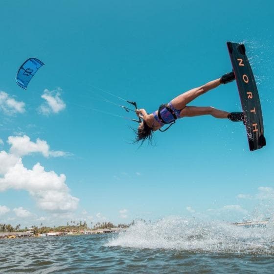 Kiteboarder jumping over turquoise ocean waves in Puerto Rico
