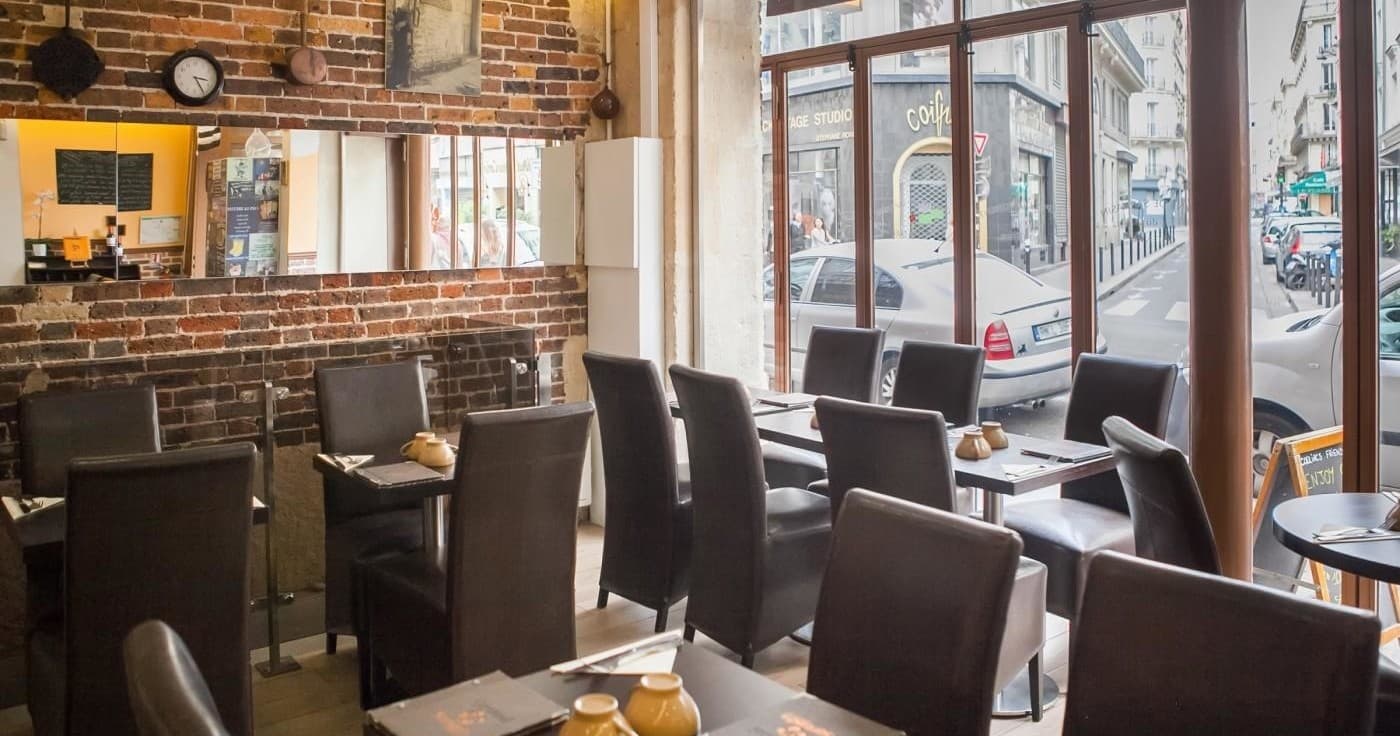 Bright cafe interior with large windows and seating area
