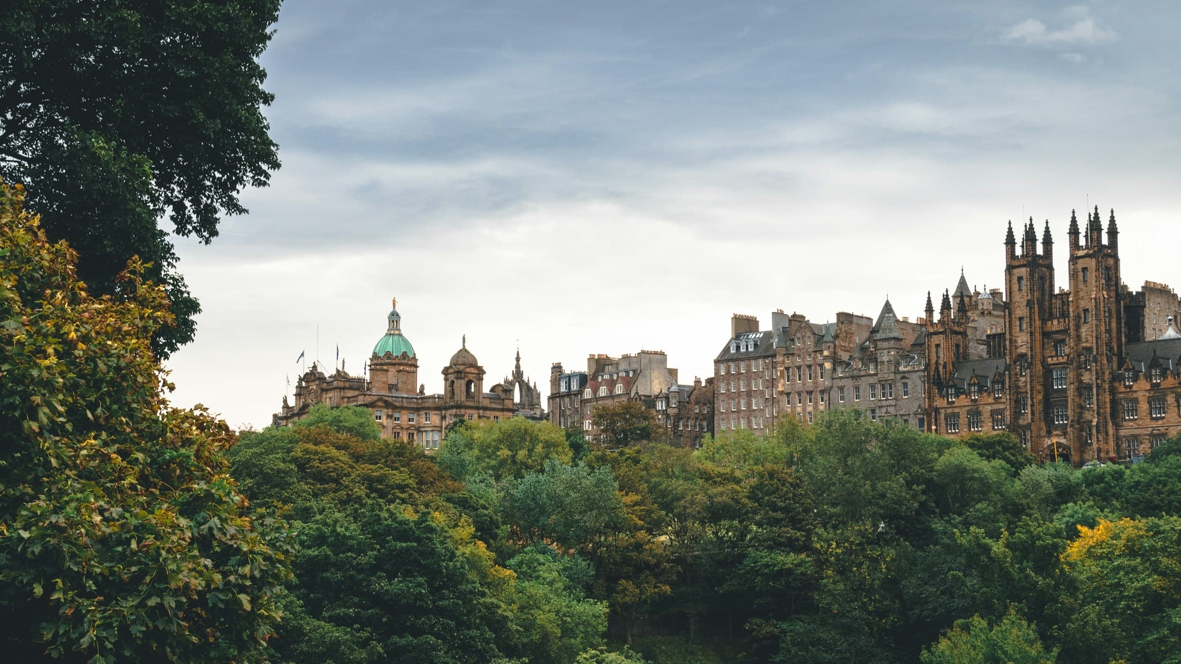 Panoramic green park and historic Edinburgh skyline view for tours