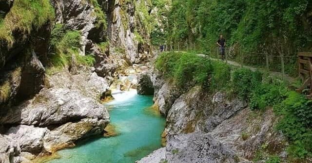 Emerald mountain river flowing through dramatic limestone gorge