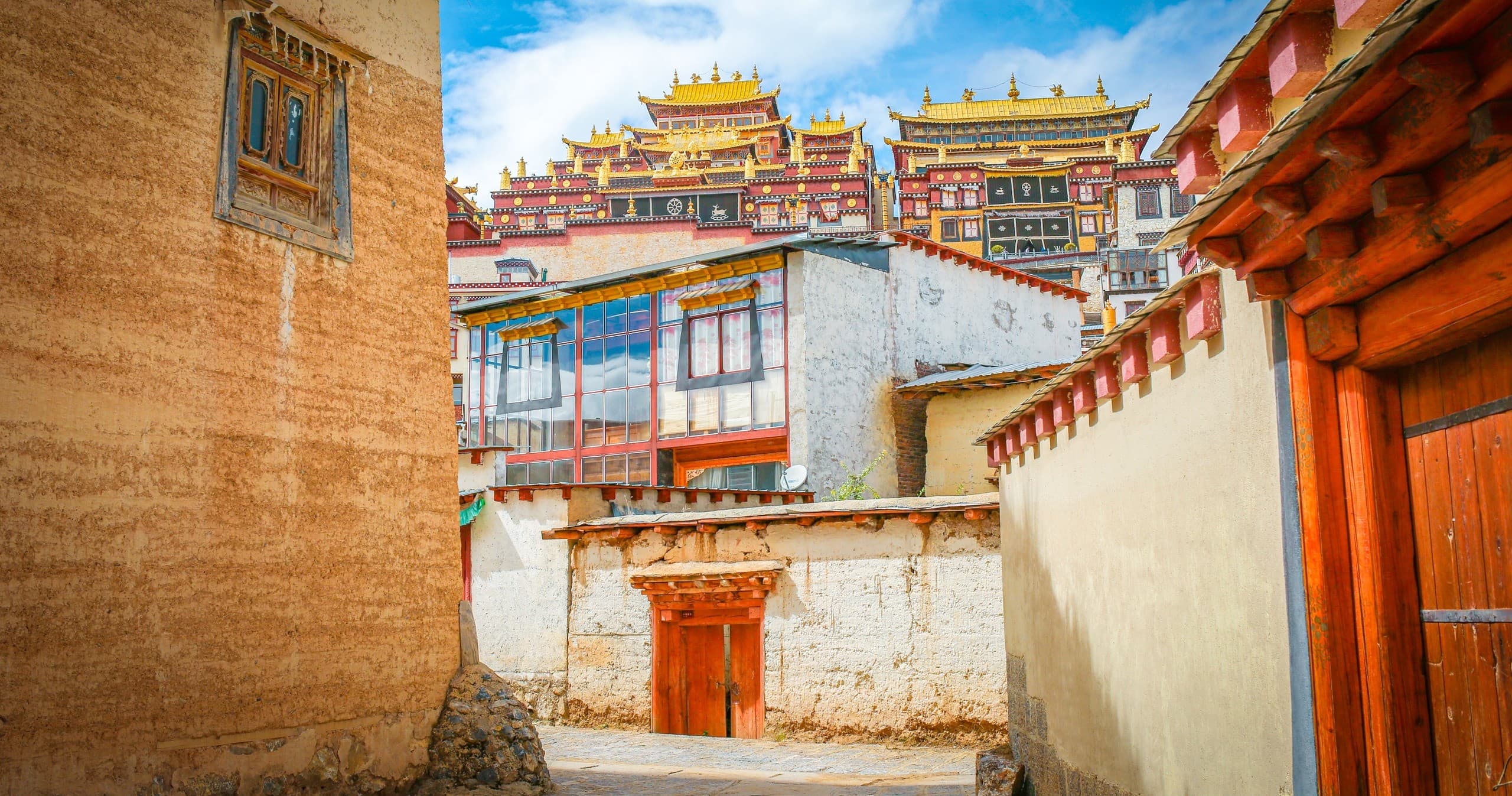 Colorful Tibetan monastery complex perched on high hillside valley
