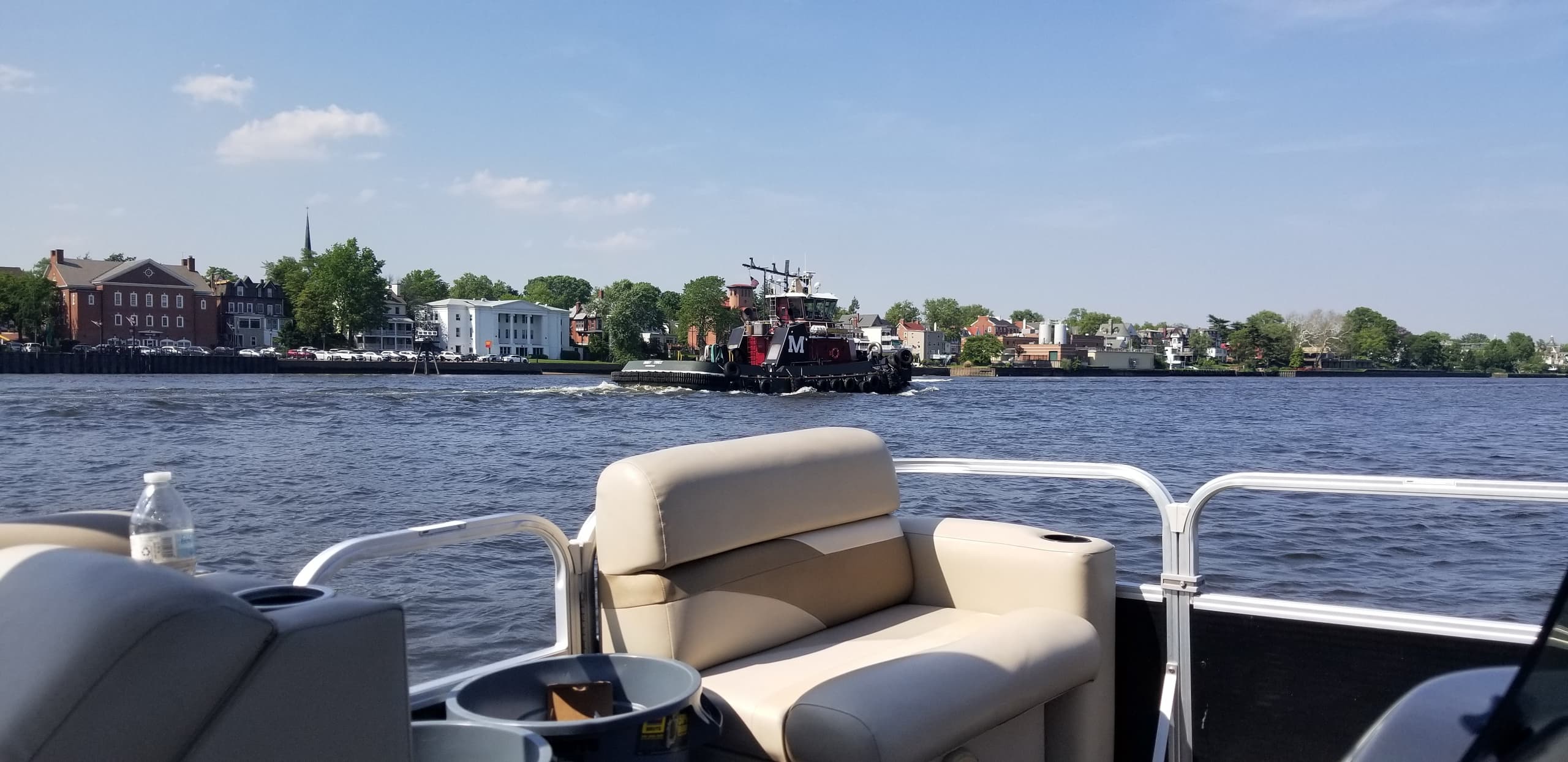 Scenic coastal town view from pontoon boat on calm water