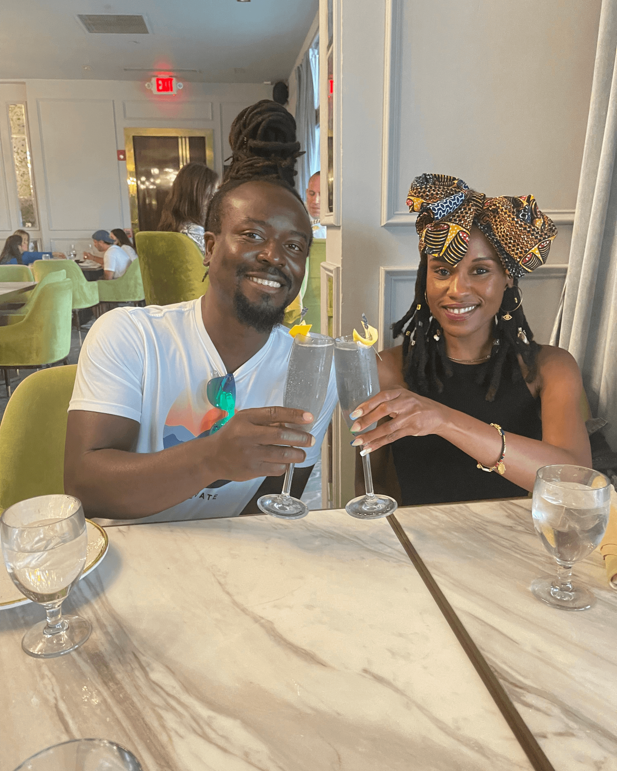 Couple toasting cocktails at indoor restaurant during San Juan food tour