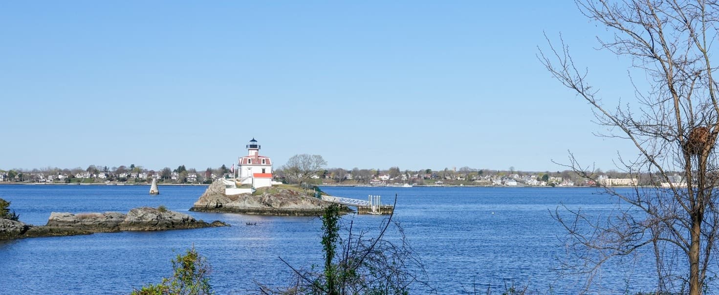 Views of Pomham Rocks Lighthouse across Narragansett Bay water