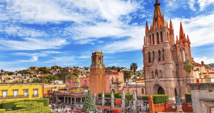 Colorful colonial cityscape with cathedral and sunny blue sky