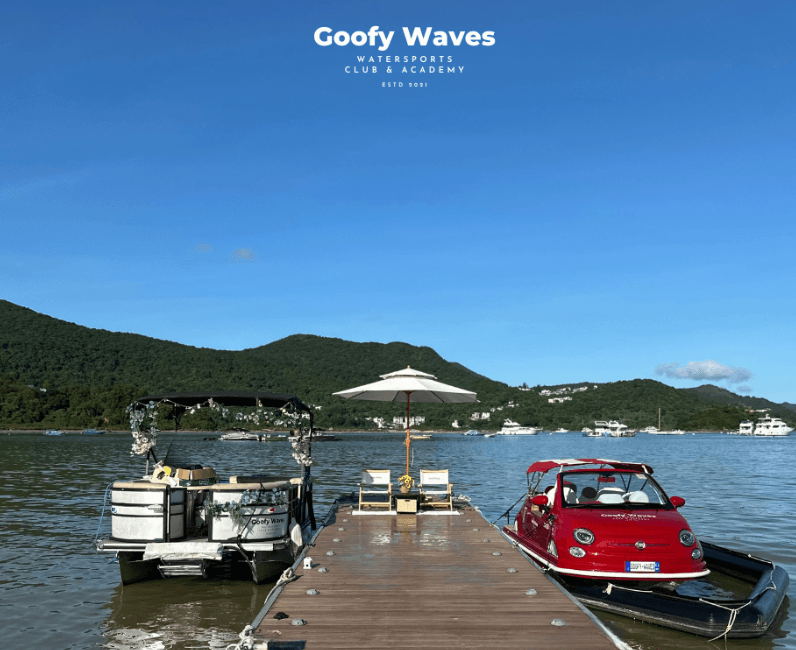 Scenic dock with boats and mountainous shoreline at sunny bay