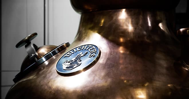 Close-up of Michter's copper pot still nameplate in distillery