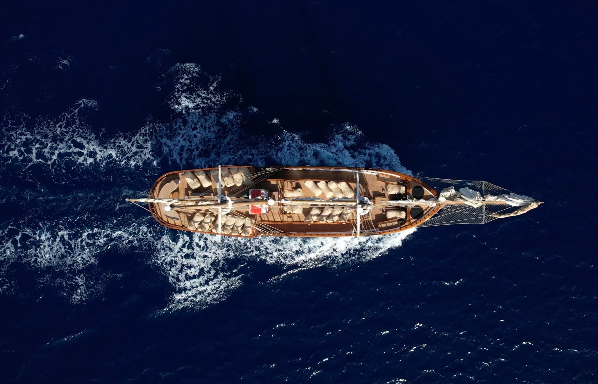 Aerial view of luxury yacht from above on deep blue Aegean Sea