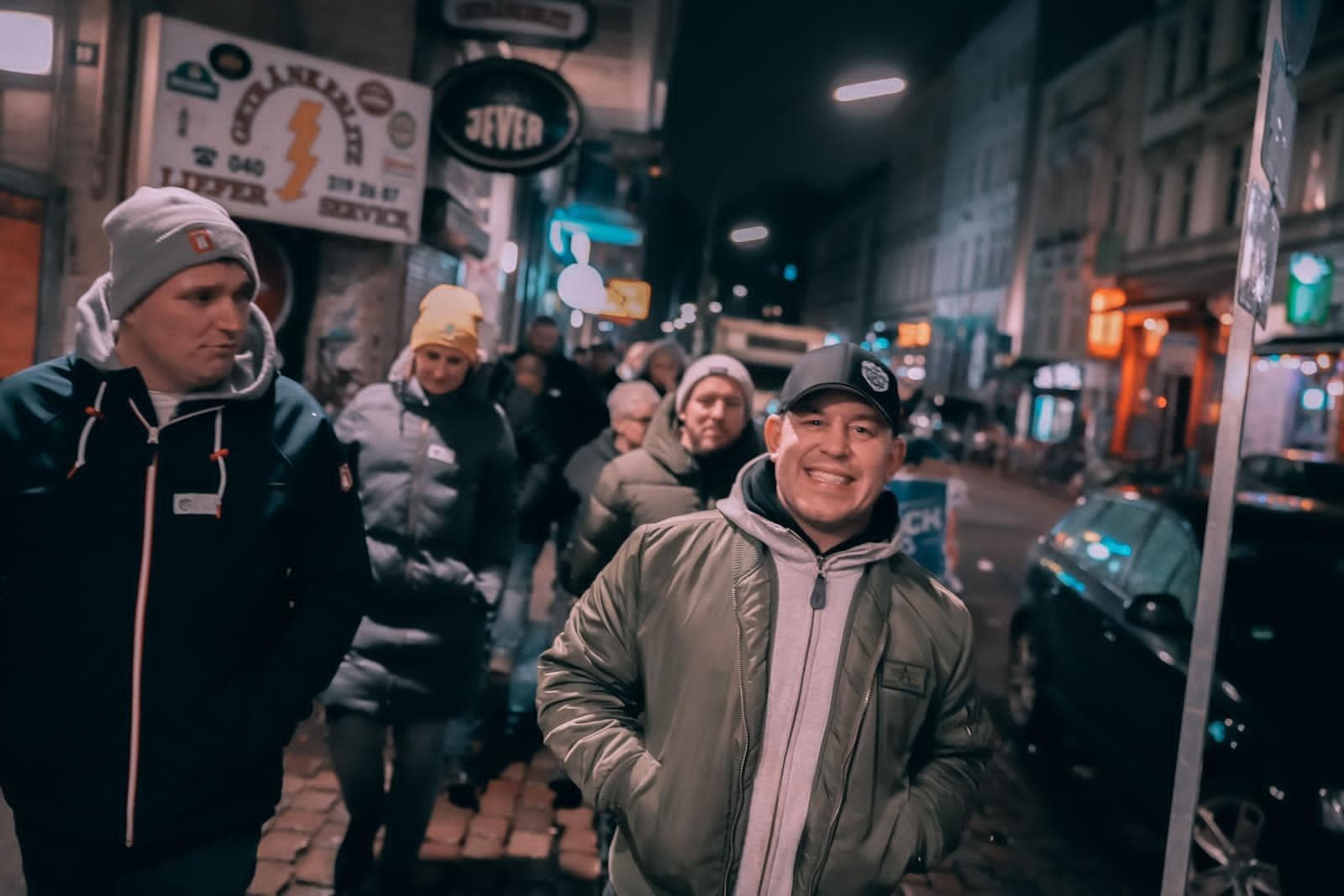 Friends walking a lively nighttime urban street tour in Europe