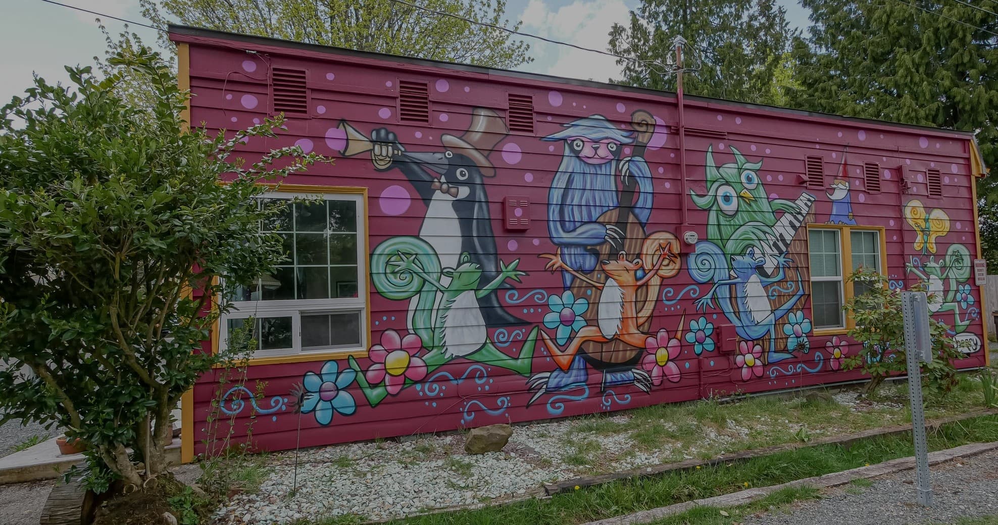 Colorful outdoor mural on red building wall in urban neighborhood