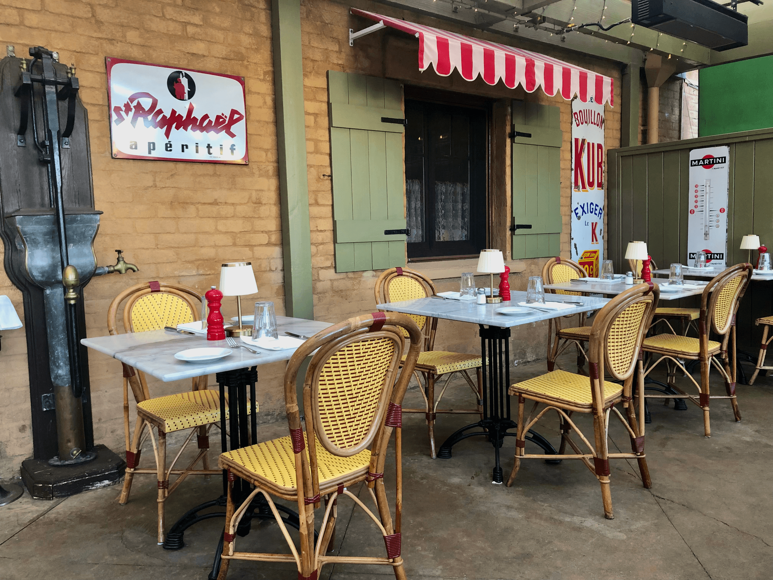 Outdoor sidewalk bistro tables and chairs on cafe patio