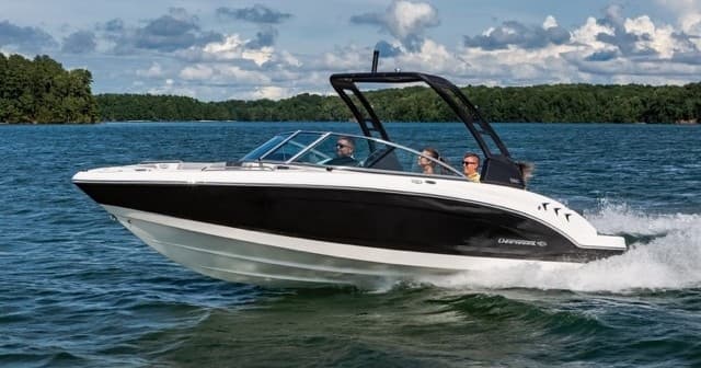 High-speed bowrider cutting through lake water with wake spray