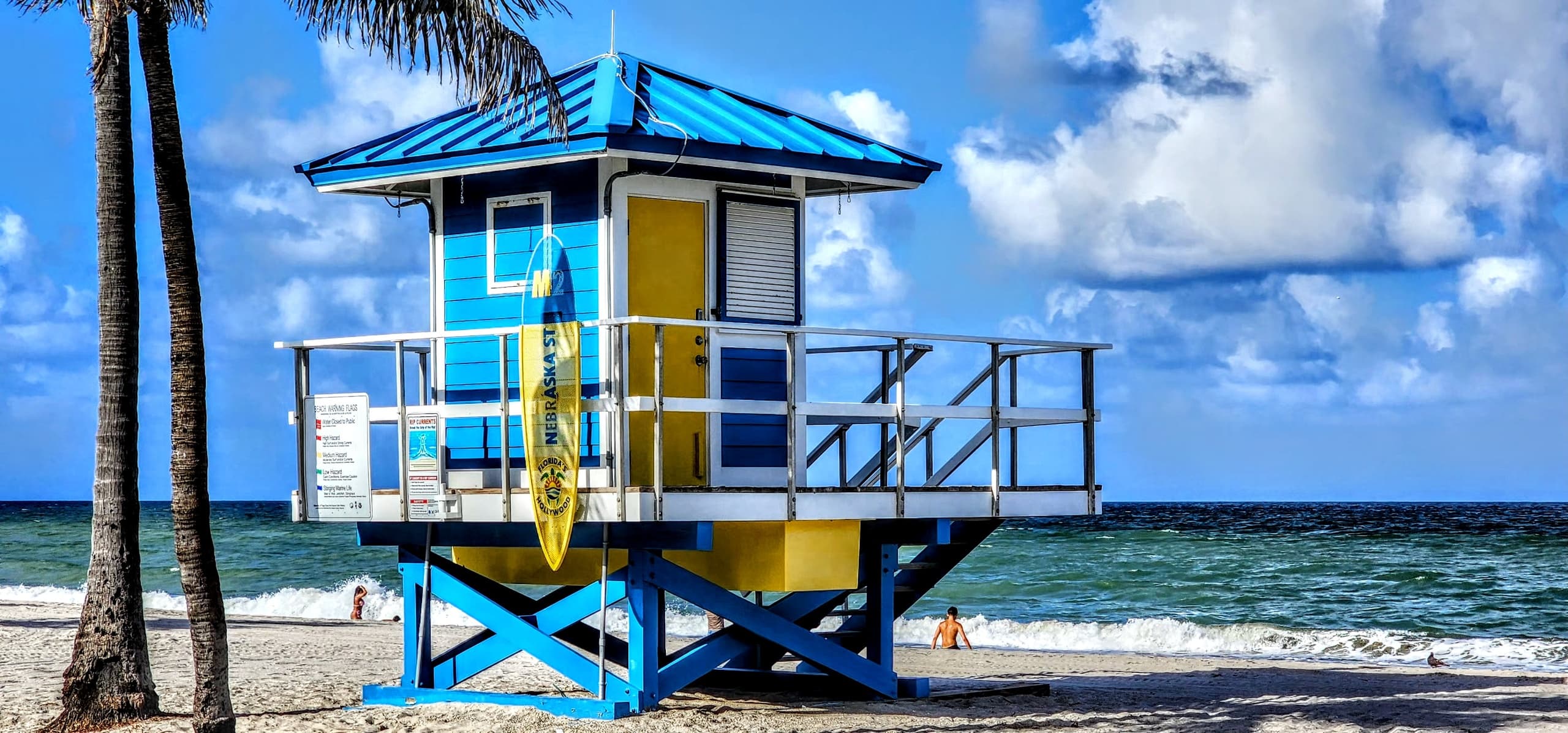 Colorful lifeguard hut on tropical sandy beach by ocean