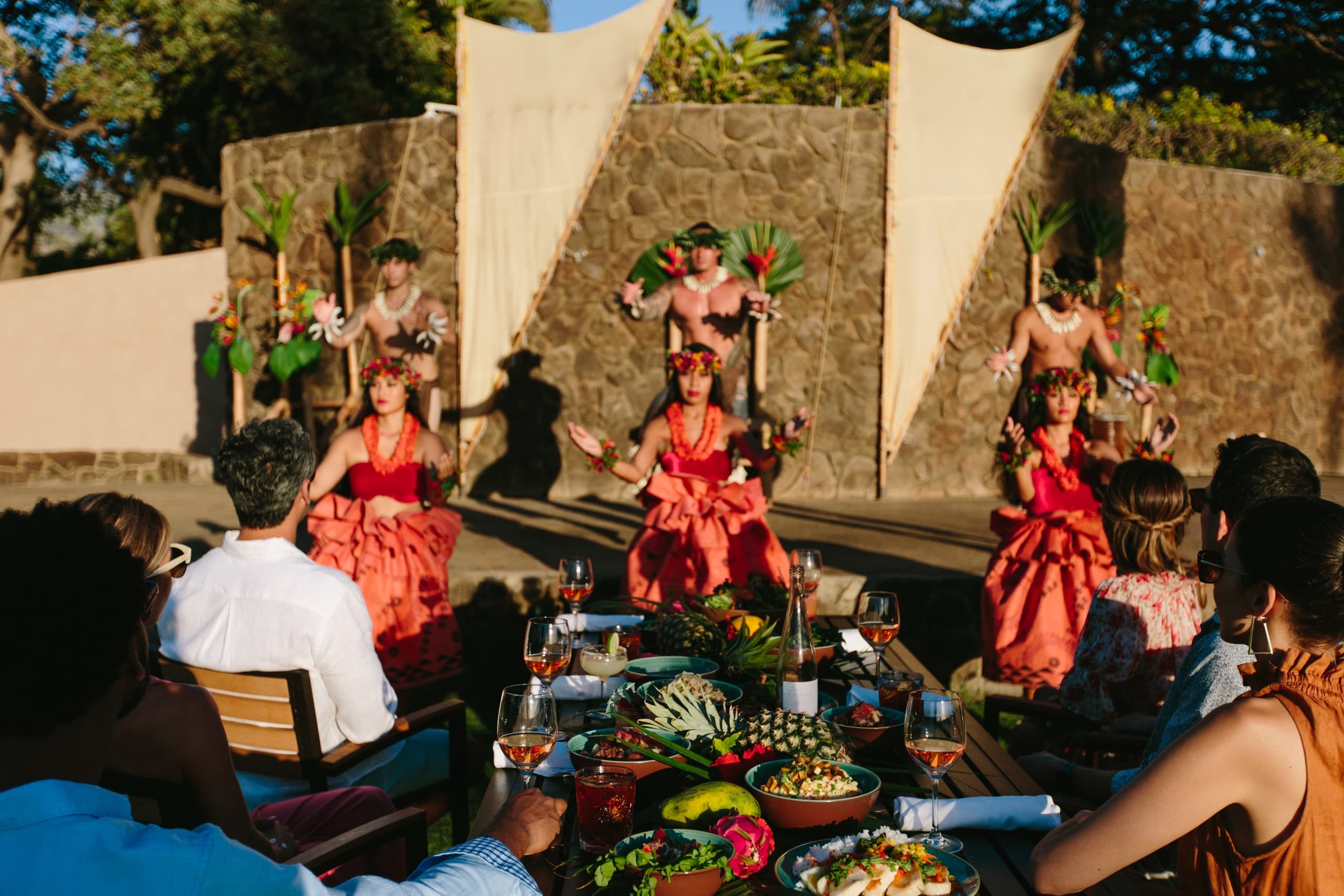 Luau performers dancing beside seaside feast at Wailea, Maui