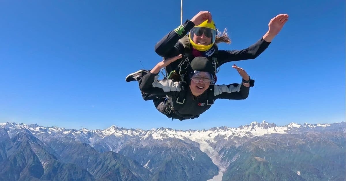Midair tandem skydive with mountain vistas in New Zealand