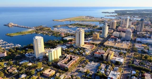 Aerial coastal cityscape over beach and marina, seaside view
