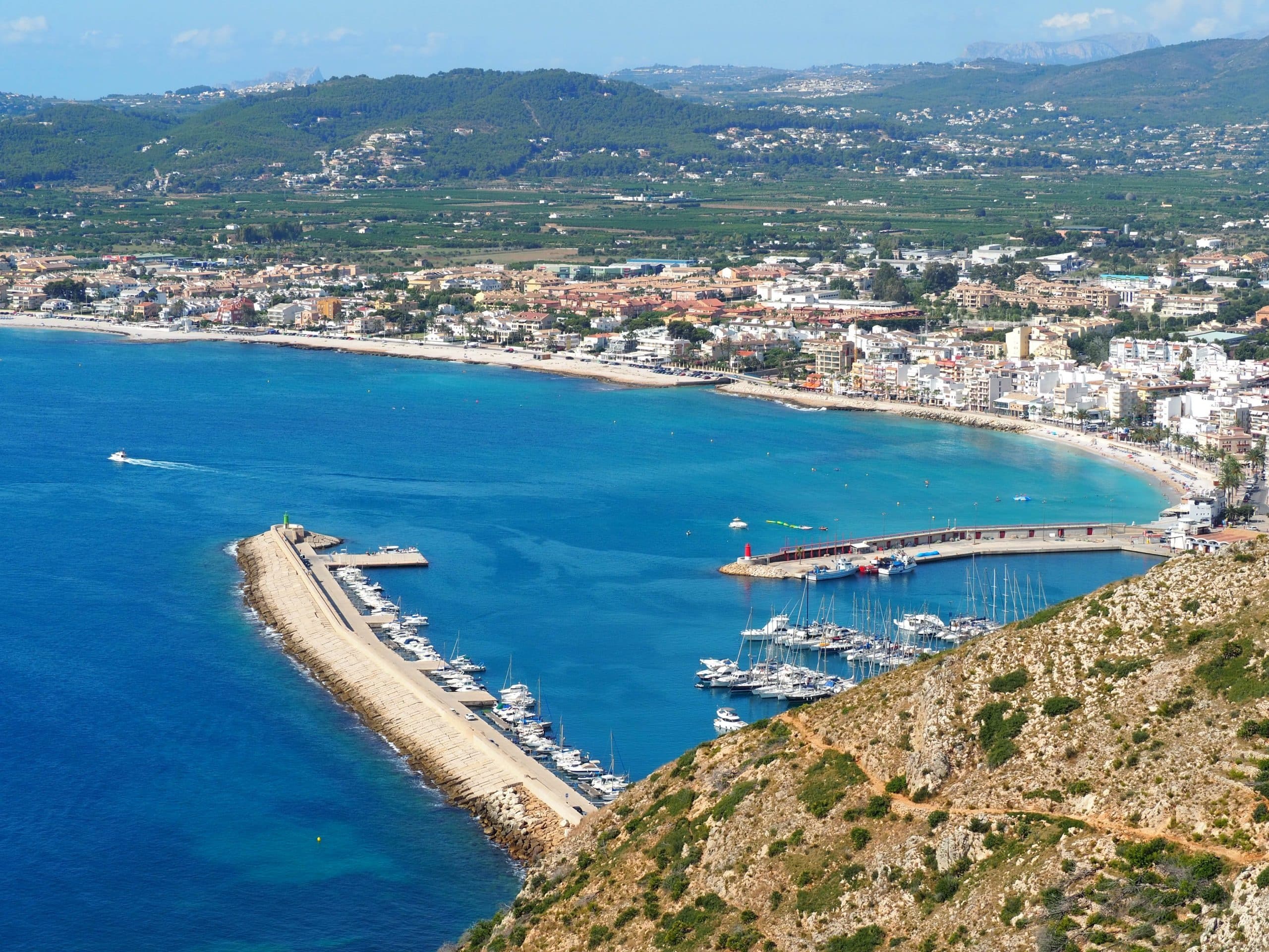 Aerial view of marina and coastline with bright blue Mediterranean