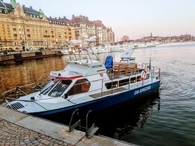 Sightseeing boat moored along Stockholm waterfront, city cruise