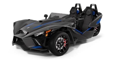 Dark Polaris Slingshot roadster with blue trim on studio white floor