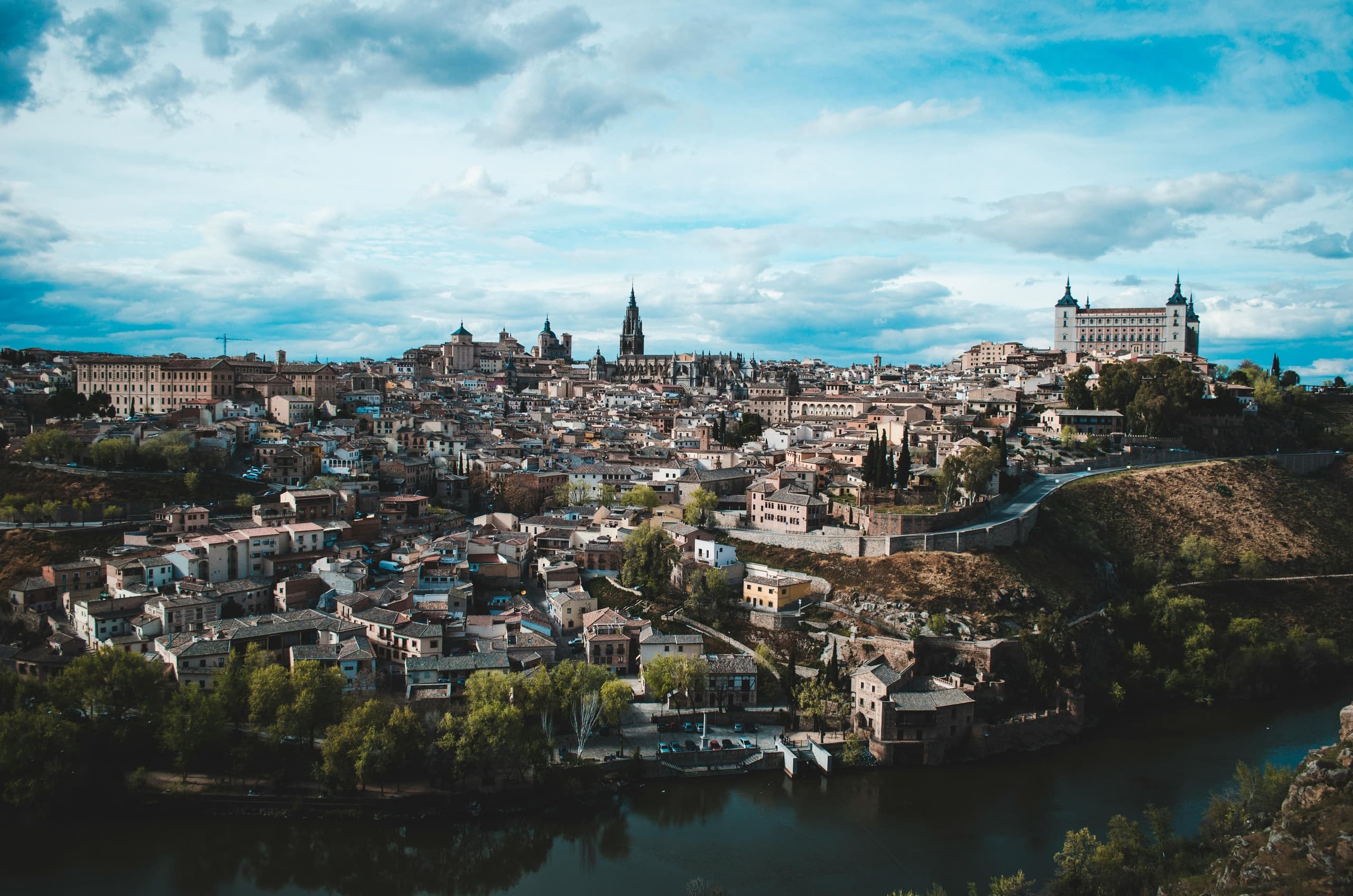 Historic hilltop town skyline over river, scenic Spain vista