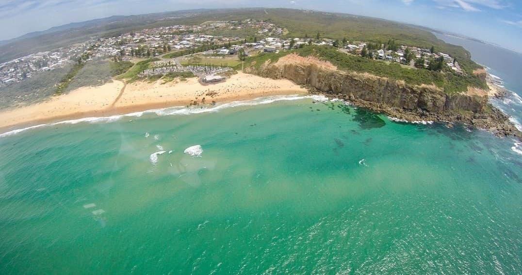 Aerial beach coastline with turquoise water and sandy shore