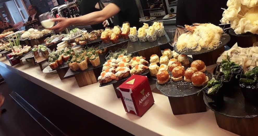 Basque pintxos spread at indoor tapas bar for culinary tasting