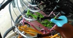 Colorful parked beach cruiser bikes close-up at rental rack