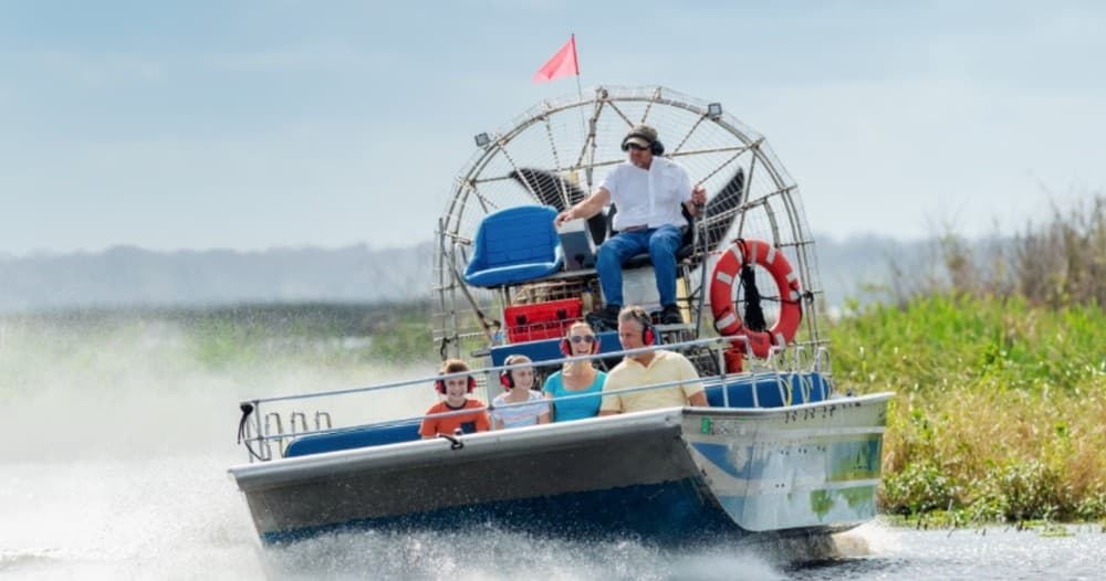 Airboat skimming water with spray in Florida wetland tour