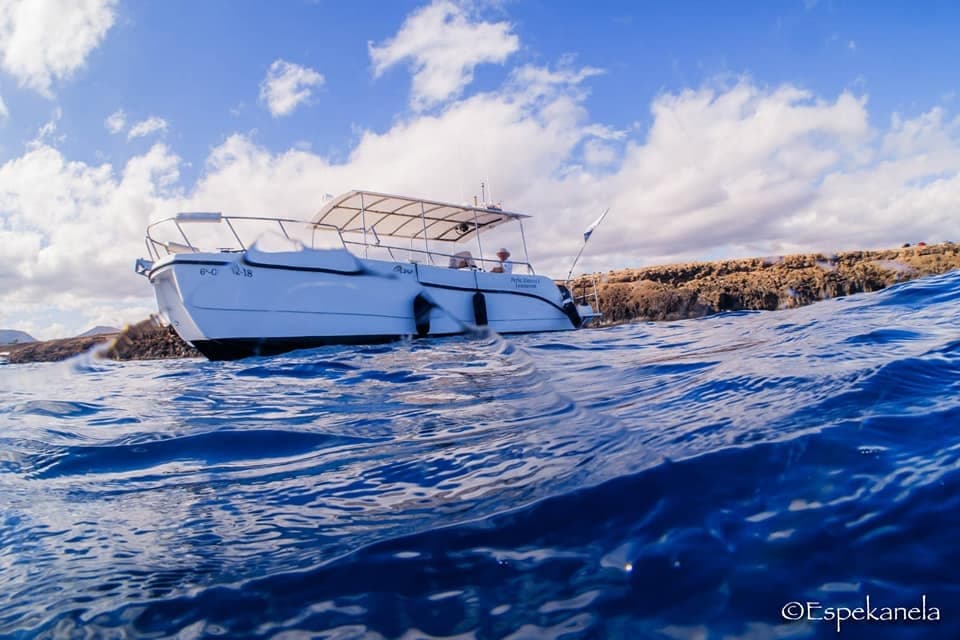 White motorboat cutting through blue Atlantic near Lanzarote