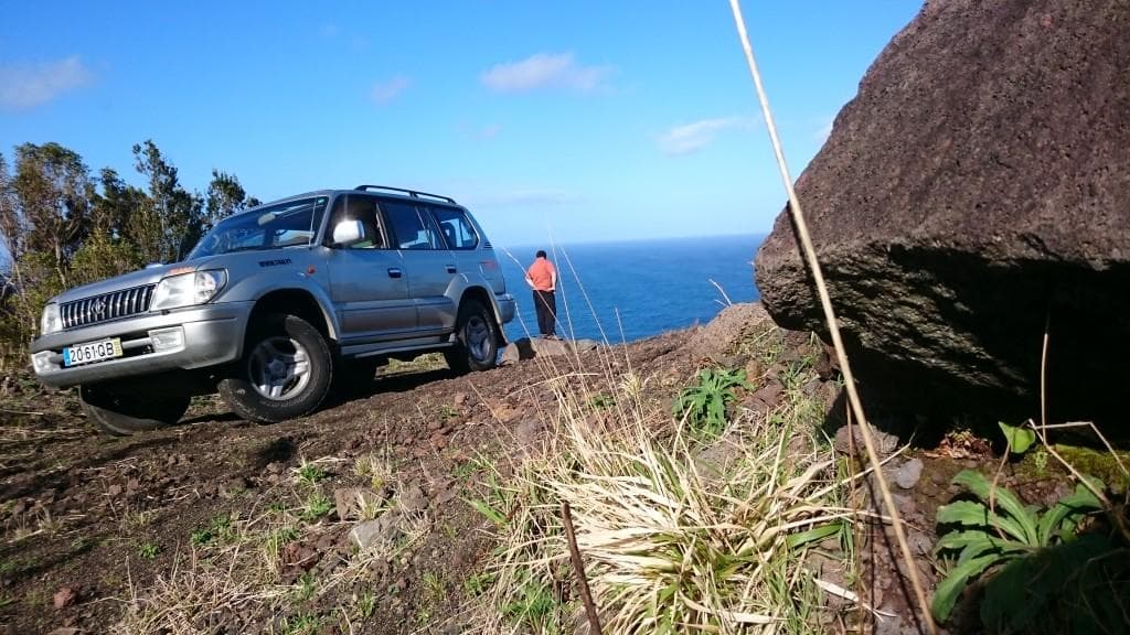 4x4 vehicle on coastal cliff track showcasing rugged offroad adventure