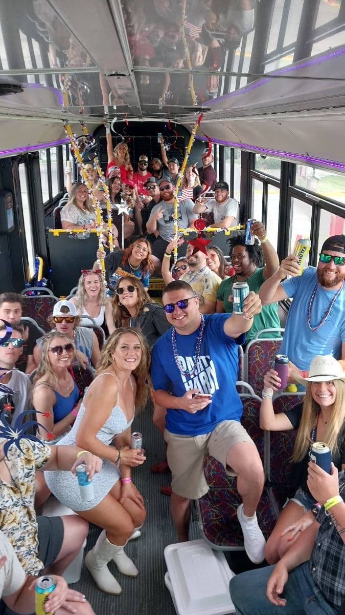 Crowded party bus interior with passengers celebrating on board