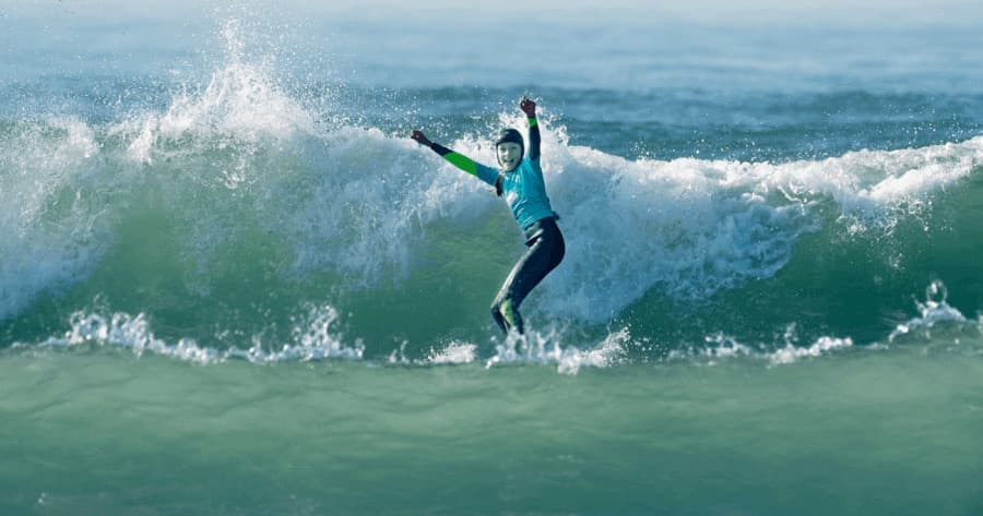 Surfer riding a powerful breaking wave in ocean
